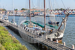 Historic sailing ship moored at pier of Dutch village Urk