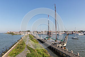 Historic sailing ship moored at pier of Dutch village Urk