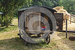 Historic shepherd`s wagon converted into a power distributor with simultaneous rain and sunshine and water vapor over the roof, i