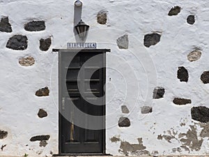 Historic Spanish library white wall signpost.