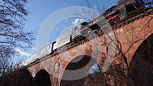 Historic steam train on the old brick bridge