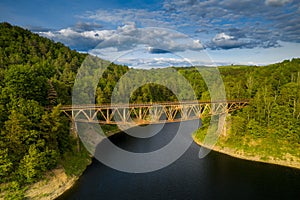 Historic steel underspanned suspension railway bridge over Bobr River in Pilchowice, Lower Silesia, Poland. Bird view on bridge