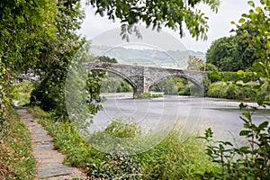 Historic steep stone arch bridge crossing a river - Pont Fawr (Inigo Jones Bridge) North Wales