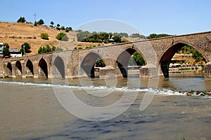 Historic stone arched bridge over the Tigris River near the city of DiyarbakÄ±r in Turkey