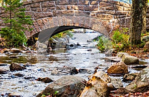 historic stone bridge on footpath around pond