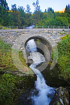 Historic stone bridge over part of the StorsÃÂ¦terfossen waterfall.  Beautiful views from FosserÃÂ¥sa hiking trail. Norway. photo