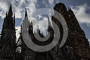 Historic stone Gothic cathedral in storm sky in the evening