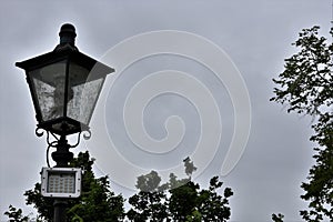 Historic street lantern and LED diode reflector for illumination of public places. Two types of illumination technologies.