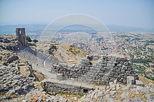 A historic theater overlooking a village downhills