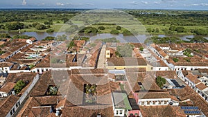 Aerial view of the historic town Santa Cruz de Mompox in sunlight with river and green sourrounding, World Heritage photo