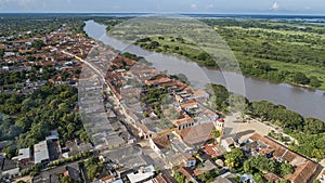 Aerial view of the historic town Santa Cruz de Mompox in sunlight with river and green sourrounding, World Heritage photo