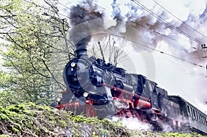 Historic train with steam lok, heavy smoke from the chimney