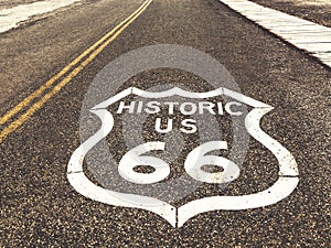 Historic US Route 66 highway sign on asphalt in Oatman, Arizona, United States. The picture was made during a motorcycle road trip