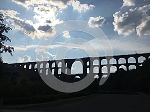 Historic Viaduct Silhouette against Cloudy Sky photo