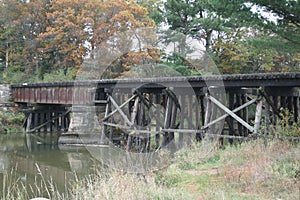 Historic, weathered rail bridge over water