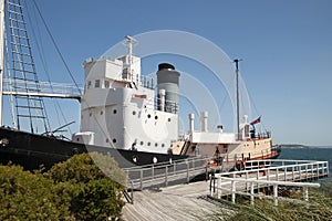 Historic whaling boat moored at wooden dock