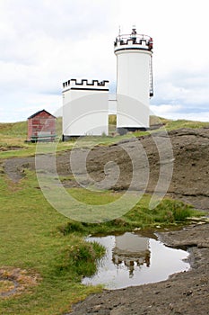 Historic white painted crenelated lighthouse
