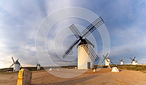 The historic white windmills of La Mancha above the town of Campo de Criptana in warm evening light