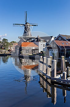 Historic windmill with reflection in the water in Haarlem