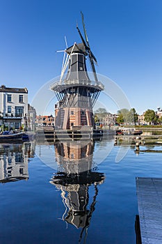 Historic windmill with reflection in the water in Haarlem