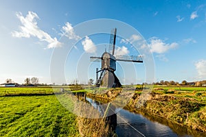 Historic wooden hollow post mill in a Dutch polder landscape