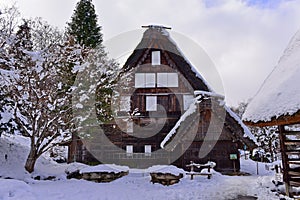 Historic wooden houses from Edo period covered in snow at Hida Folk Village in Takayama, Japan