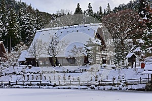 Historic wooden houses from Edo period covered in snow at Hida Folk Village in Takayama, Japan