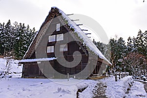 Historic wooden houses from Edo period covered in snow at Hida Folk Village in Takayama, Japan