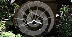 A historic wooden wheel on the water surface in Tokyo handheld shot