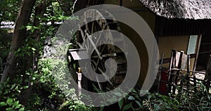 A historic wooden wheel on the water surface in Tokyo handheld shot