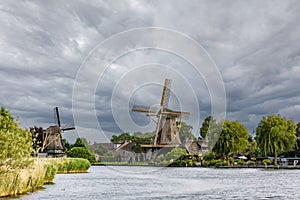 Historic wooden windmill on the canal bank in the Netherlands