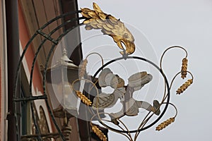 Historic wrought-iron guild sign of a bakery.