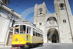 Historic yellow tram in front of the Lisbon Cathedral, Portugal