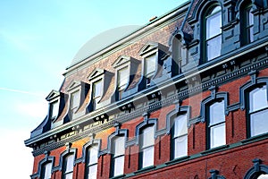 Historical architecture building ancient ornements brick facade roof windows photo