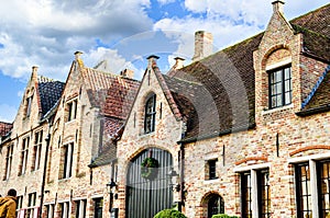 Historical architecture in the city of Bruges, Belgium against a blue cloudy sky