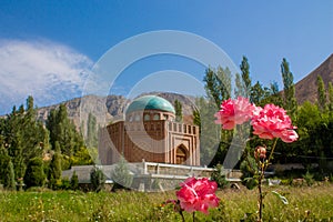 Historical beautiful mausoleum monument decorated with rose flowers in Tajikistan