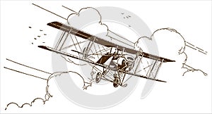 Historical biplane flying out of the clouds