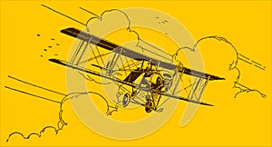 Historical biplane flying out of the clouds on a yellow-orange background