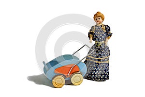 Historical blonde doll in dark dress with doll cart