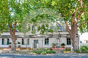 Historical building beneath large oak trees