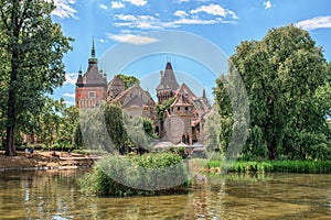 Historical building in Budapest - Vajdahunyad Castle with lake over the blue sky in main City Park.