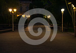 Historical building campus European medieval architecture empty street night square illuminated by lantern lights