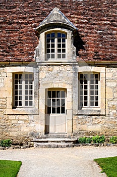 Historical building entrance door with vintage windows