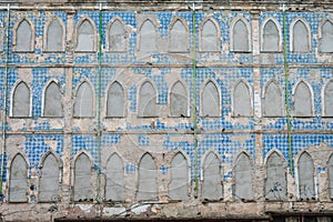 Historical building with Portuguese tiles abandoned and with windows shut closed with cement next to Modelo market in Salvador photo