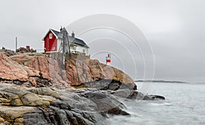 Historical building and small lighthouse in the area of FemÃÂ¶re, Sweden