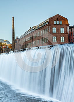 Historical building and waterfall in the area or Museum of Work in Norrkoping