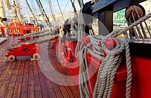 Historical cannon of an old wooden sailboat. Details deck of the ship.