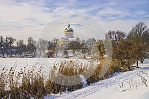 Historical church of Smila on the shore of the frozen lake. Cherkasy region, Ukraine