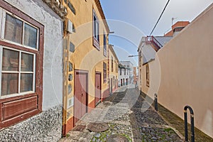 Historical city street view of residential houses in small and narrow alley or road in tropical Santa Cruz, La Palma