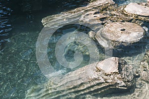 Historical Cleopatra pool and ancient ruins in the Hierapolis Ancient City. Pamukkale Cotton castle, Denizli, Turkey